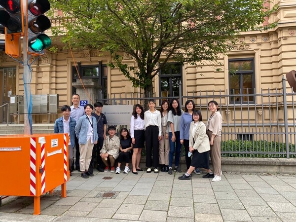 A group photo in front of the firm